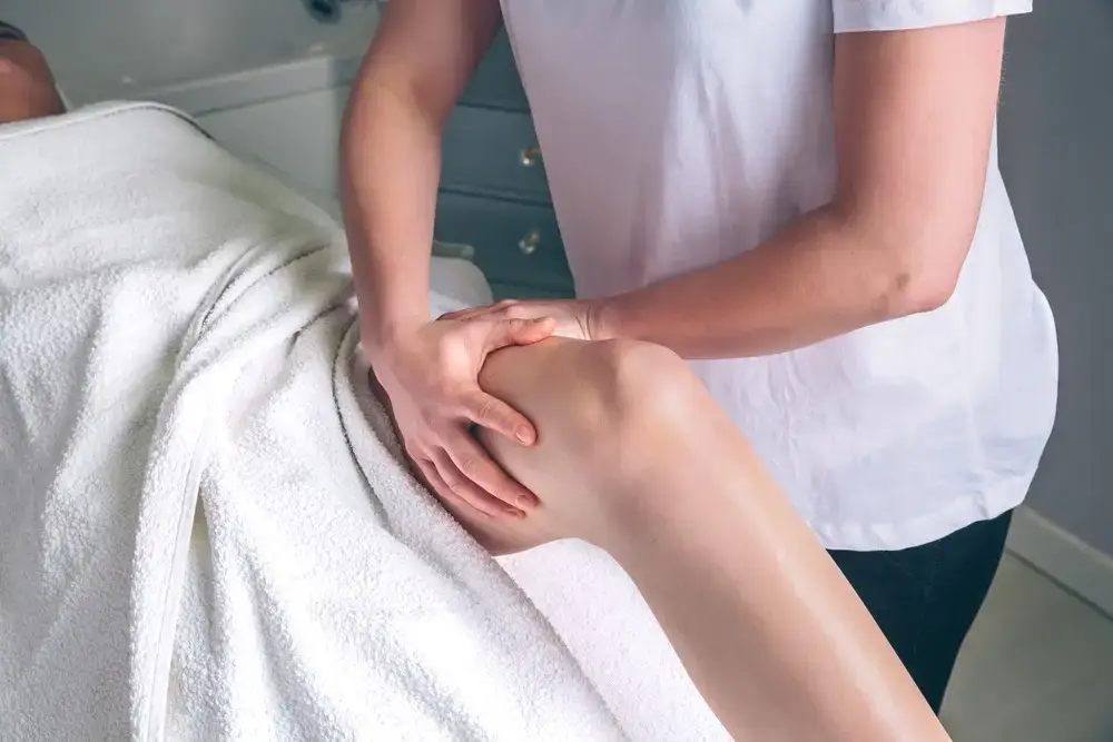 Certified lymphatic drainage massage therapist performing manual lymphatic drainage to reduce swelling and improve circulation