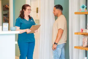 Massage therapist at Balance Spa Boca Raton discussing treatment options with client